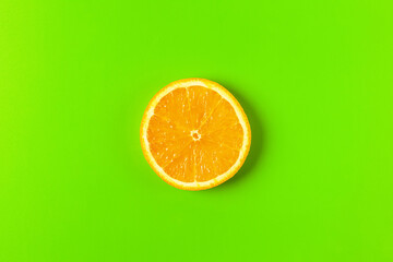 orange slice on a green background macro. place for the label