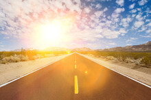 Straight Desert Road With Strong Sunshine