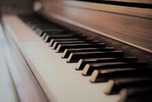 Close Up Macro View Of Rustic Brown Upright Piano Keyboard. Selective Focus With Vanishing Point.