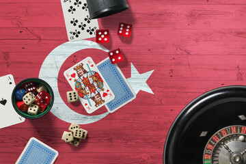 Wall Mural - Turkey casino theme. Aces in poker game, cards and chips on red table with national wooden flag background. Gambling and betting.