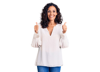 Wall Mural - Middle age beautiful woman wearing casual sweater success sign doing positive gesture with hand, thumbs up smiling and happy. cheerful expression and winner gesture.