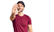 © Krakenimages.com - Handsome hispanic man wearing casual clothes doing stop sing with palm of the hand. warning expression with negative and serious gesture on the face.
