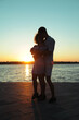© MagicsPhotos - Happy in love couple dancing at sunset on the beach