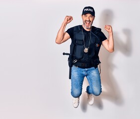 Middle age handsome man wearing police unifrom smiling happy. Jumping with smile on face doing ok sign with fists up over isolated white background