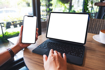 Wall Mural - Mockup image of a woman using tablet pc with blank white desktop screen as a computer pc with mobile phone