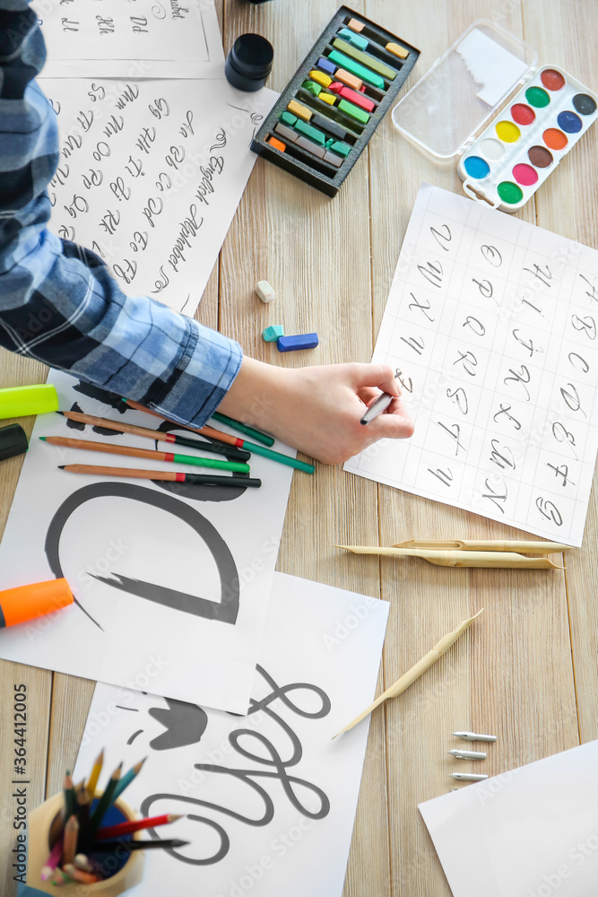 Female calligraphist working in office