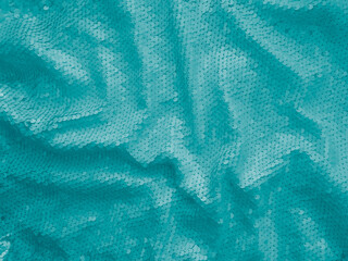 Wall Mural - Background fabric sequin in turquoise color. Holiday abstract glitter background with blinking lights. Fashion fabric glitter. 