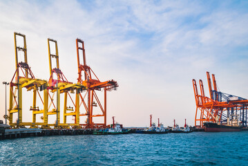 Wall Mural - Quay crane standing on jetty harbor. Container handling equipment, heavy machinery for container logistics industry. 