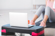 © Pixel-Shot - Sporty young woman with laptop training at home