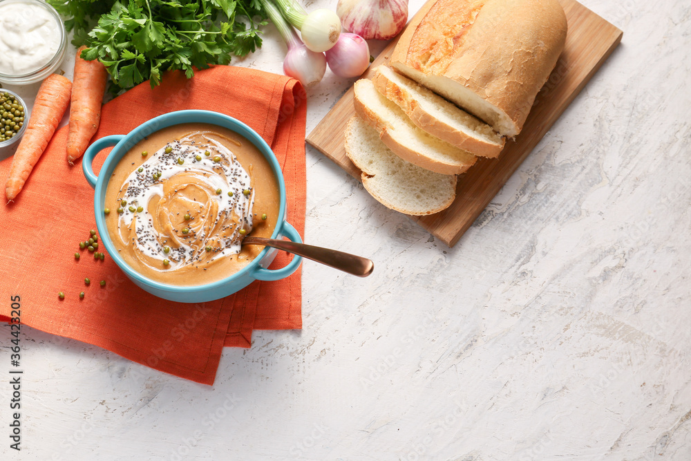 Pot of tasty lentils soup with bread on table