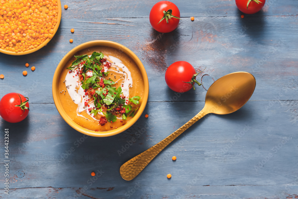 Bowl of tasty lentils soup on table