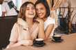 © halayalex - Two young beautiful smiling hipster girls in trendy summer casual clothes.Carefree women chatting in veranda terrace cafe and drinking coffee.Positive models having fun and communicating