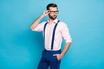 Sticker - Photo of handsome macho business man cool clothes guy eyesight care vision touch hand specs look side empty space wear pink shirt suspenders pants isolated pastel blue color background