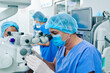 © DragonImages - Mature surgeon in gloves and medical mask using modern equipment when performing laser eye vision correction operation