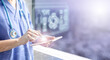 © Paulista - female doctor touching a tablet displaying the patient's data hologram, concept of electronic medical information and futuristic technology in health care