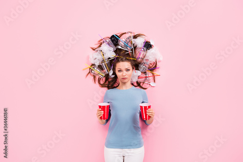 Top view above high angle flat lay flatlay lie concept of responsible conscious girl with junk in hair holding in hands punch cups solution decision reuse choice isolated pink pastel color background