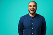 © fotofabrika - Joyful dark-skinned man laughing against turquoise background