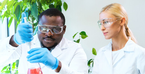 Scientist and students working in lab. Doctor teaching interns to make blood analyzing research. Coronavirus, chemistry, bacteriology, virology and health care