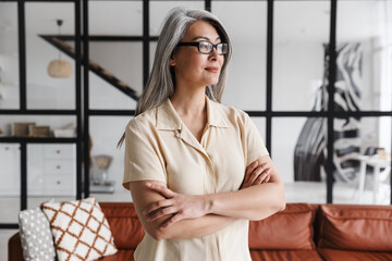 Canvas Print - Photo of beautiful gray-haired asian woman posing with arms crossed