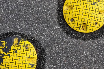 Sticker - Closeup surface texture of an old asphalt road with speed bump in northern Europe