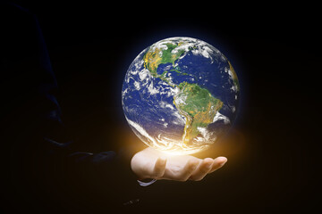 Canvas Print - environment concept. earth in human hands on black background. elements of this image furnished by n