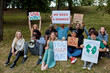 © Roman - young diverse people protest with placards and posters on global strike for climate change. save our planet from plastic pollution