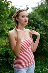 Wall Mural - The beautiful girl is walking outdoors. Girl in the park. Girl on nature. Woman outside. Positive woman smiling