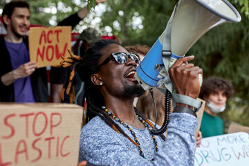 young diverse people protest with placards and posters on global strike for climate change. save our planet from plastic pollution