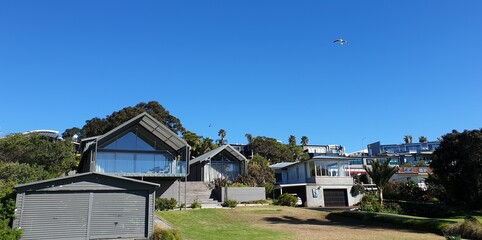 Poster - Houses of the village next to each other under the blue sky