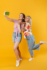 Canvas Print - Portrait of two cheerful lovely girlfriends standing