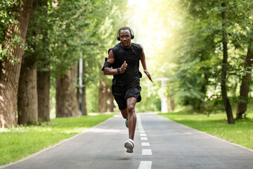 Motivated african man training at public park