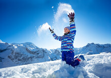 Close Action Portrait Ski Girl Who Throw Snow In The Air Standing On Her Knee's Over Mountain Top Range View