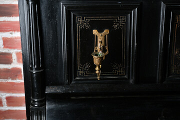 Wall Mural - old black piano with copper candlesticks against a brick wall