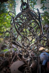 Canvas Print - Vertical closeup shot of hanging metal chain-shaped details