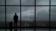 © realstock1 - The man with suitcase standing near the big windows in the business center