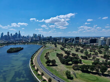 Aerial View Of A Beautiful Sunny Day At The Albert Park And Lake, With The Golf Course And Melbourne Skyline