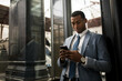 © Widetape/ADDICTIVE STOCK - Trendy black businessman using phone