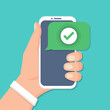 © stas111 - Hand holding smartphone with check icon in a flat design