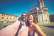 © photomaticstudio - happy Tourist couple visit city center of Modena in the main square of the city taking selfie photo together. Major destination in Emilia-Romagna, Italy