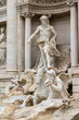 Closeup side view of the statues of the Trevi Fountain in Rome. Italy. Vertically. 