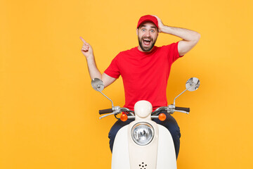 Wall Mural - Delivery man in red cap t-shirt uniform driving moped motorbike scooter isolated on yellow background studio Guy employee working courier Service quarantine pandemic coronavirus virus covid-19 concept