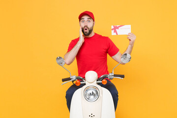 Wall Mural - Delivery man in red cap t-shirt uniform driving moped motorbike scooter hold certificate isolated on yellow background studio Guy employee working courier Service quarantine pandemic covid-19 concept