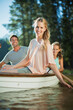 © Paul Bradbury/KOTO - Smiling family in rowboat on lake