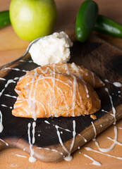 Apple Turnover Dessert. Classic American or French bakeries or pastry shop favorites. Cookies, whipped cream, cakes, chocolate syrup butter, eggs and vanilla beans.