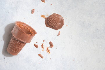 Wall Mural - A waffle cup with ice cream, and melting ice cream on a white background, with creative lightA waffle cup with ice cream, and chocolate melting ice cream on a white background, with creative light