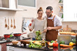 © amenic181 - Loving young Asian couple cooking in kitchen making healthy food together feeling fun