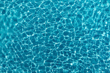  Beautiful blue crystal clear water texture with small ripples on the surface.