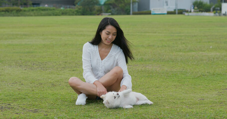 Wall Mural - Woman plays with her dog at park