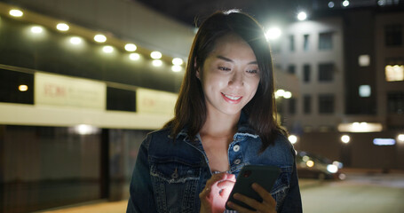 Poster - Woman use of mobile phone in city at night