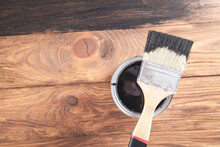 Black Paint And Brush On Wooden Background.